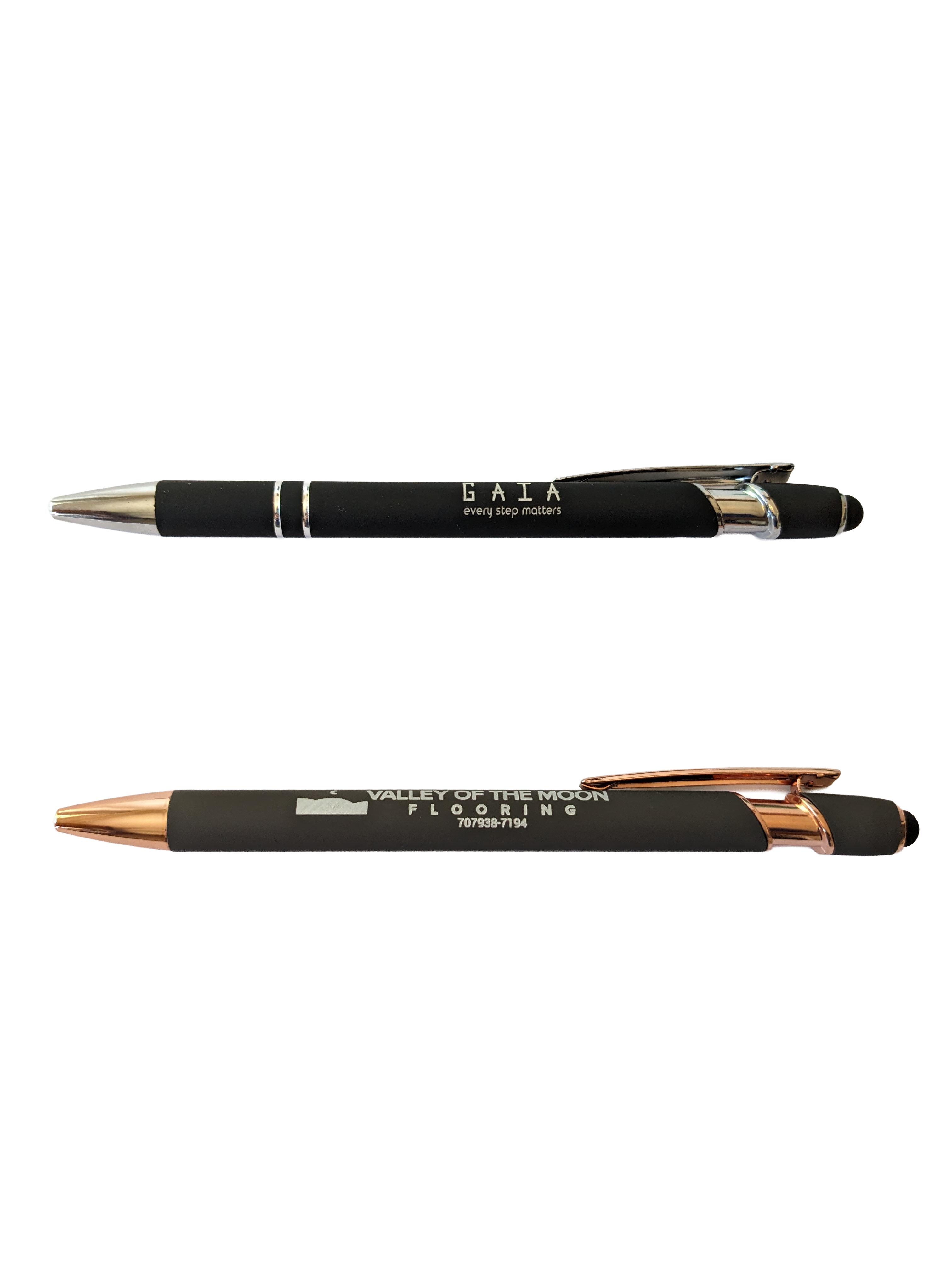 Two custom matte black stylus ballpoint pens with silver and rose gold trim showing sample GAIA and Valley of the Moon Flooring branding
